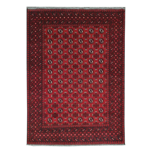 Full view of Afghan Turkoman hand-knotted wool rug with red field, dark motifs and ivory accents, 240 x 168 cm
