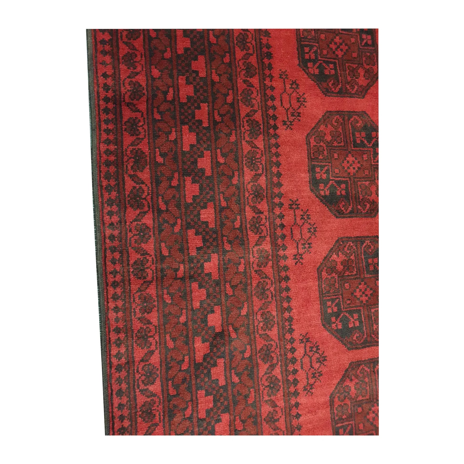Border and field detail of Afghan Turkoman wool rug showing red pile, dark charcoal patterning and ivory accents