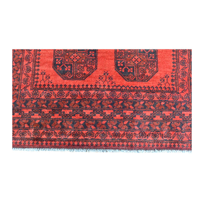 End-border detail of Afghan Turkoman rug showing dark diamond bands beneath the red gul field and white fringe