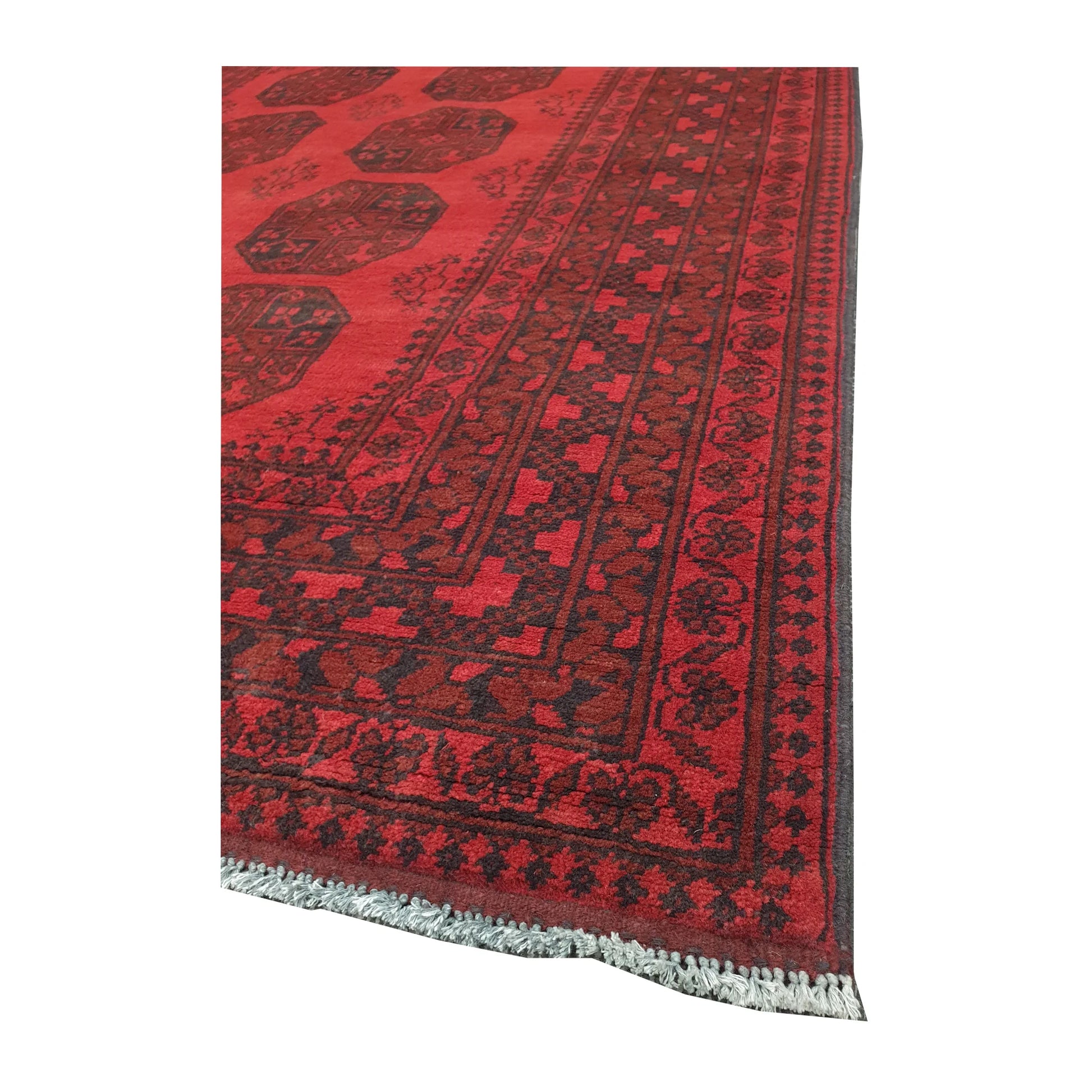 Corner and fringe detail of Afghan Turkoman hand-knotted wool rug with layered geometric border