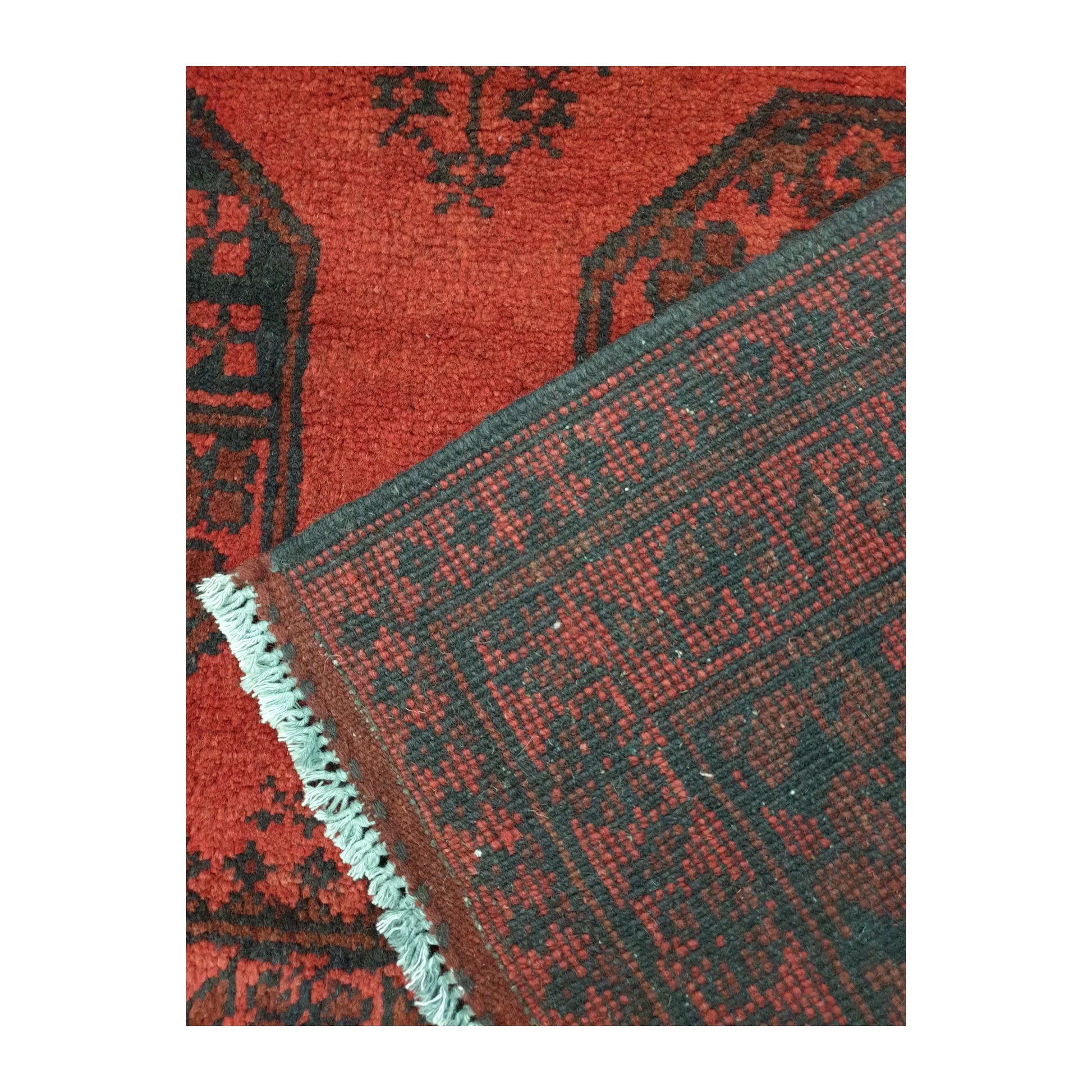 Reverse-weave and fringe detail of Afghan Turkoman wool rug showing back structure and hand-knotted pattern