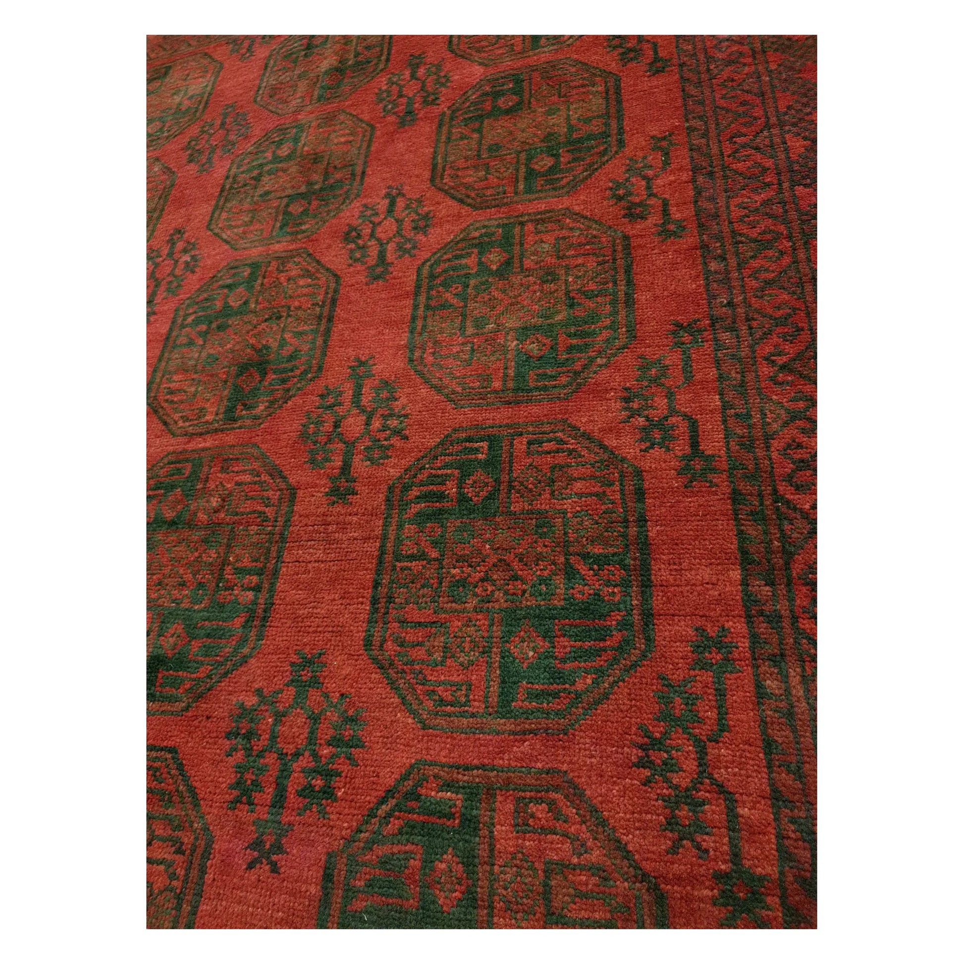 Close-up of Turkoman hand-knotted rug with repeating red gul pattern and dark tribal detailing, 291 x 203 cm
