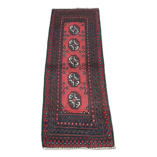 Full view of Afghan Turkoman hand-knotted wool runner rug with red field, five octagonal gul motifs and layered black borders, 130 x 52 cm