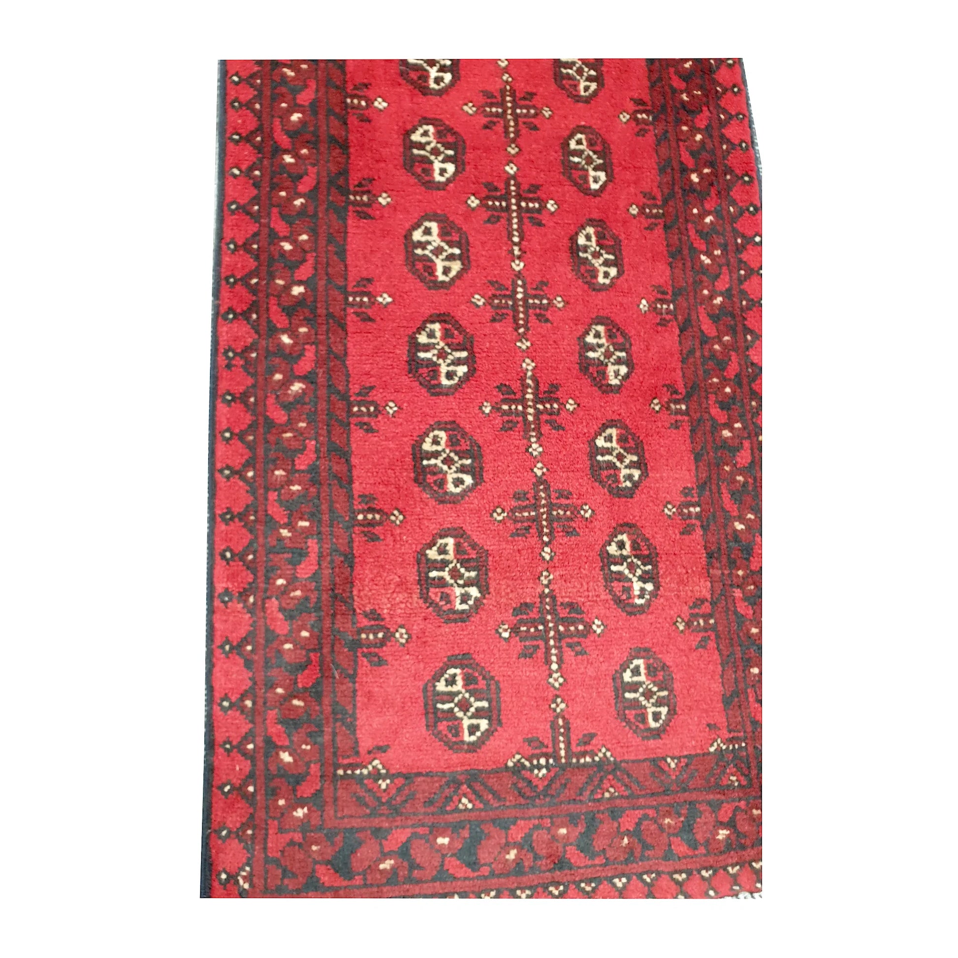 Border and field detail of Afghan Turkoman wool runner rug showing red pile, dark charcoal patterning and ivory accents