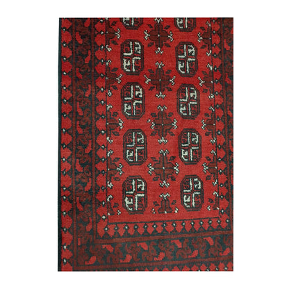 Border and field detail of Afghan Turkoman wool runner rug showing red pile, dark charcoal patterning and ivory accents