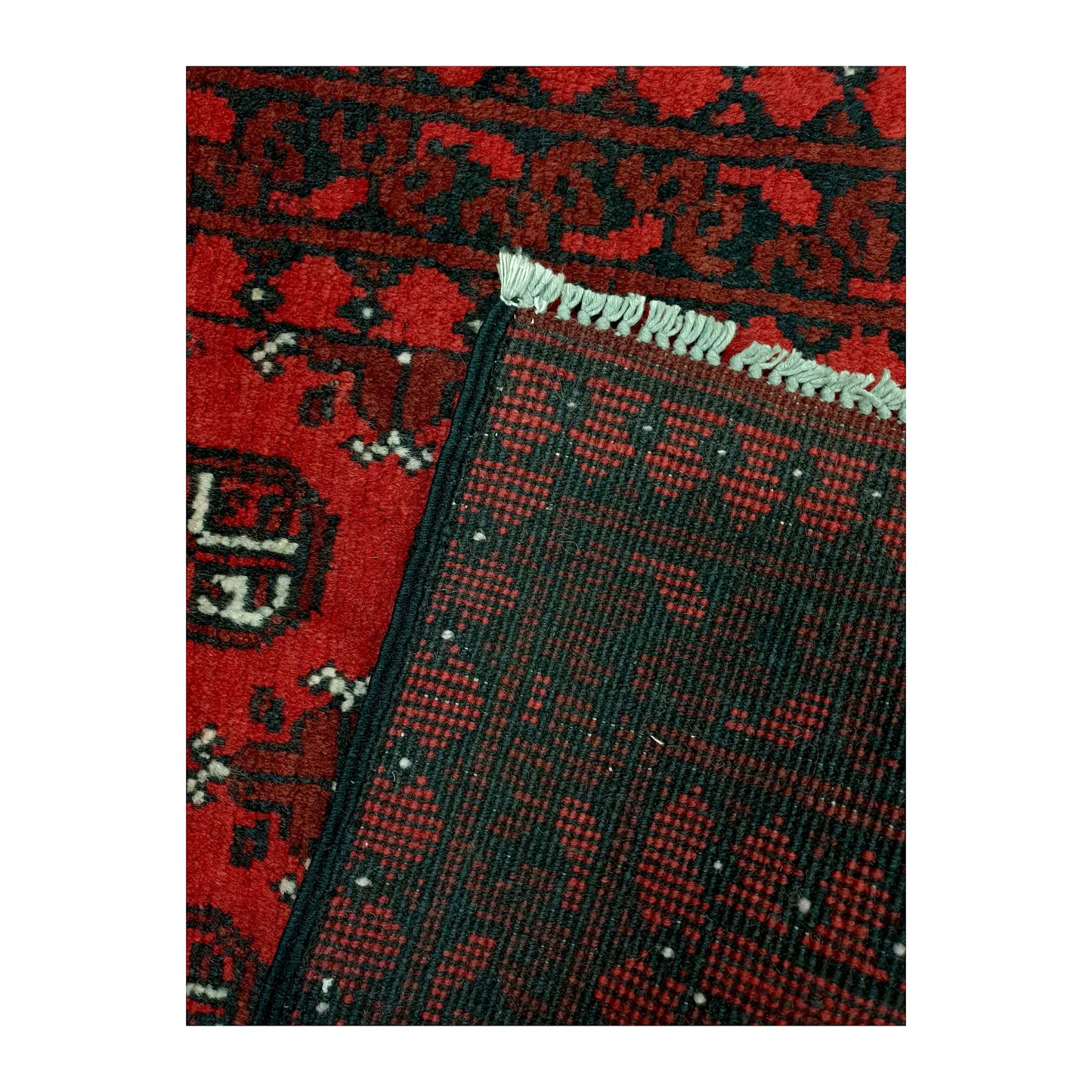 Reverse-weave and fringe detail of Afghan Turkoman wool runner rug showing back structure and hand-knotted pattern