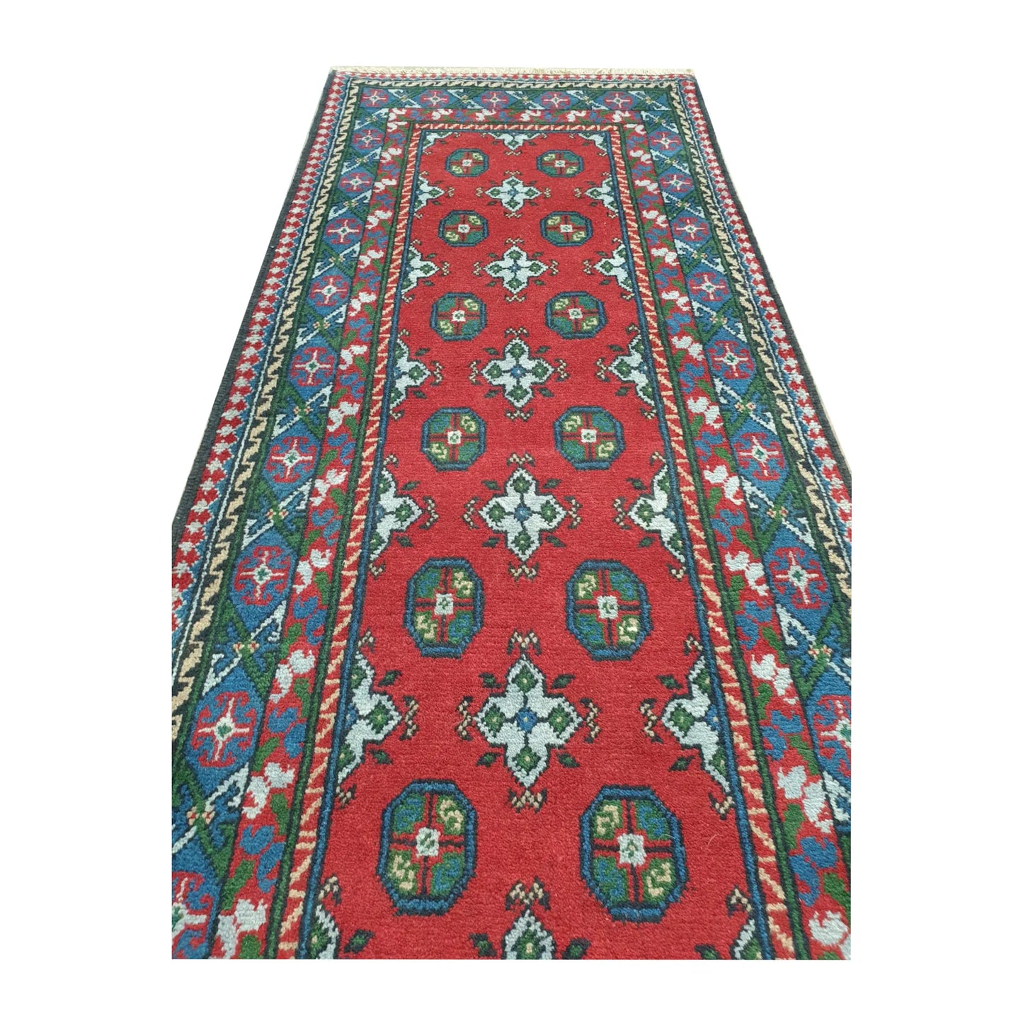 Field pattern detail of Afghan Turkoman runner rug showing repeated gul motifs and hand-knotted wool texture