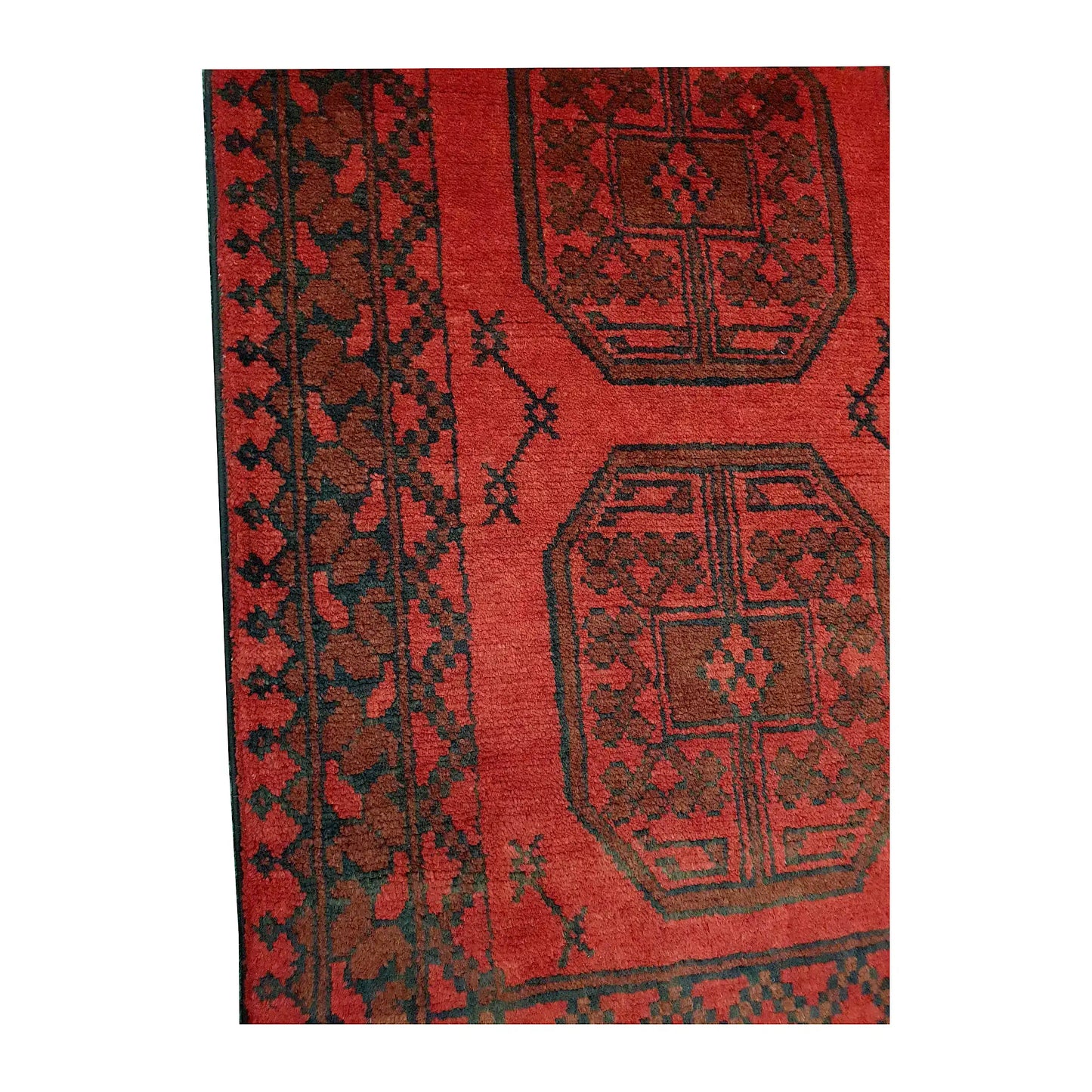 Border and field detail of Afghan Turkoman wool runner rug showing red pile, dark medallions and geometric border