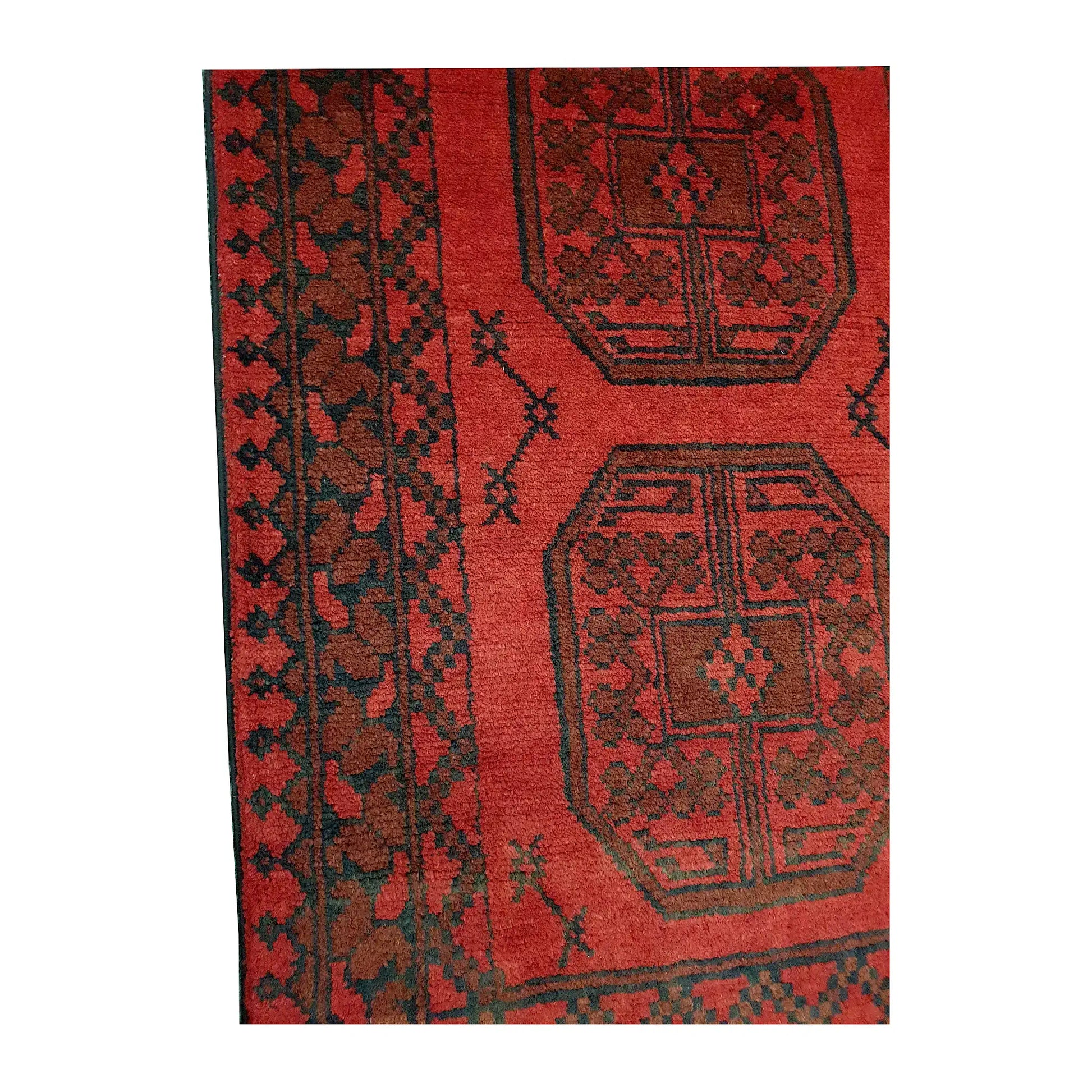 Border and field detail of Afghan Turkoman wool runner rug showing red pile, dark medallions and geometric border