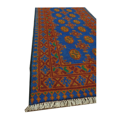 Border and fringe detail of Afghan Turkoman hand-knotted wool runner rug with blue and orange pattern