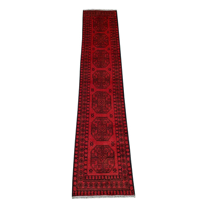Full view of Afghan Turkoman hand-knotted wool runner rug with red field and repeated gul-style medallions, 298 x 58 cm