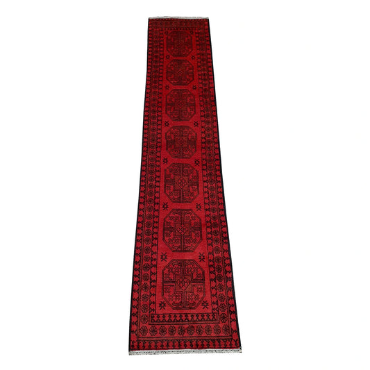 Full view of Afghan Turkoman hand-knotted wool runner rug with red field and repeated gul-style medallions, 298 x 58 cm
