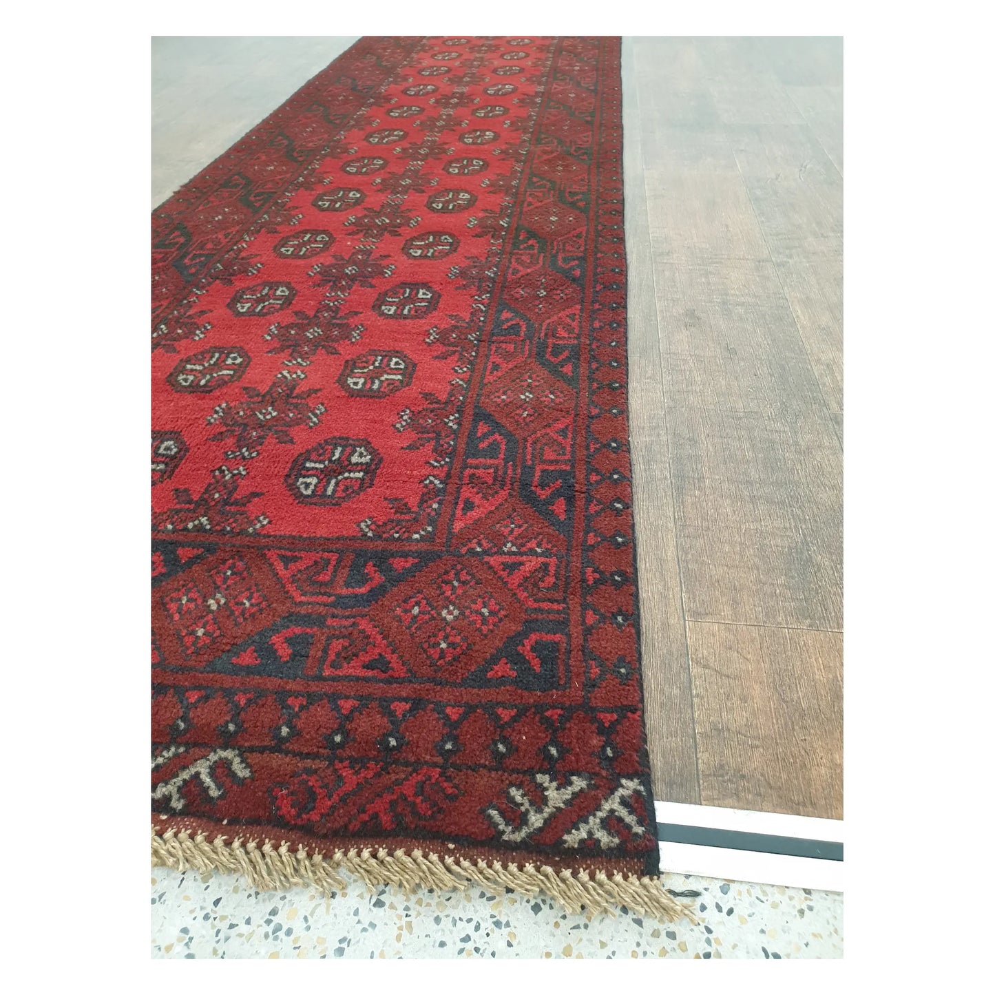 Angled detail of Turkoman runner showing border pattern, fringe, and hand-knotted wool texture, 568 x 75 cm