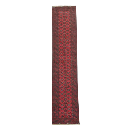 Full view of Afghan Turkoman hand-knotted wool runner rug with repeating red gul motifs, 568 x 75 cm