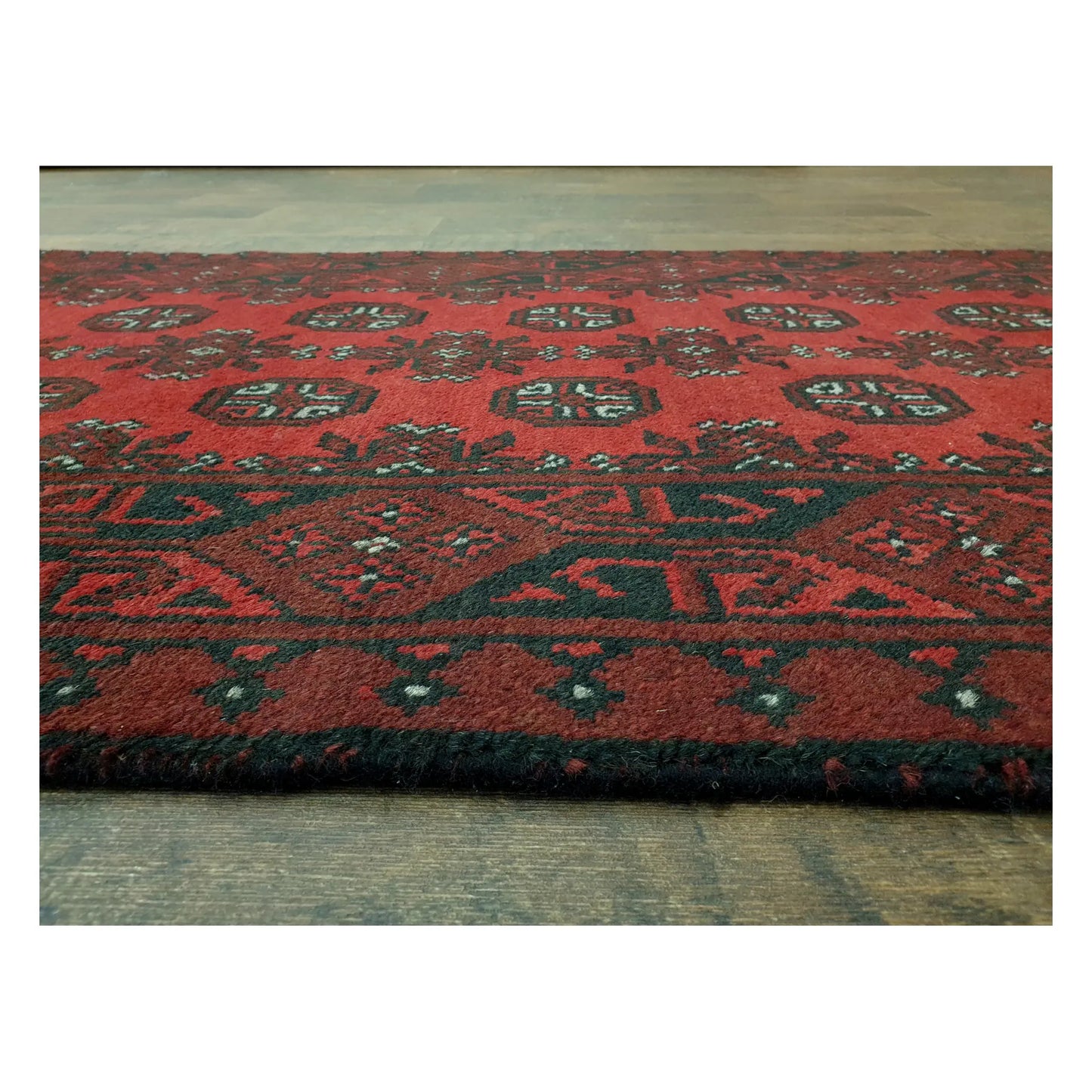 Low-angle close-up of Turkoman runner showing wool pile texture and geometric border detail, 568 x 75 cm