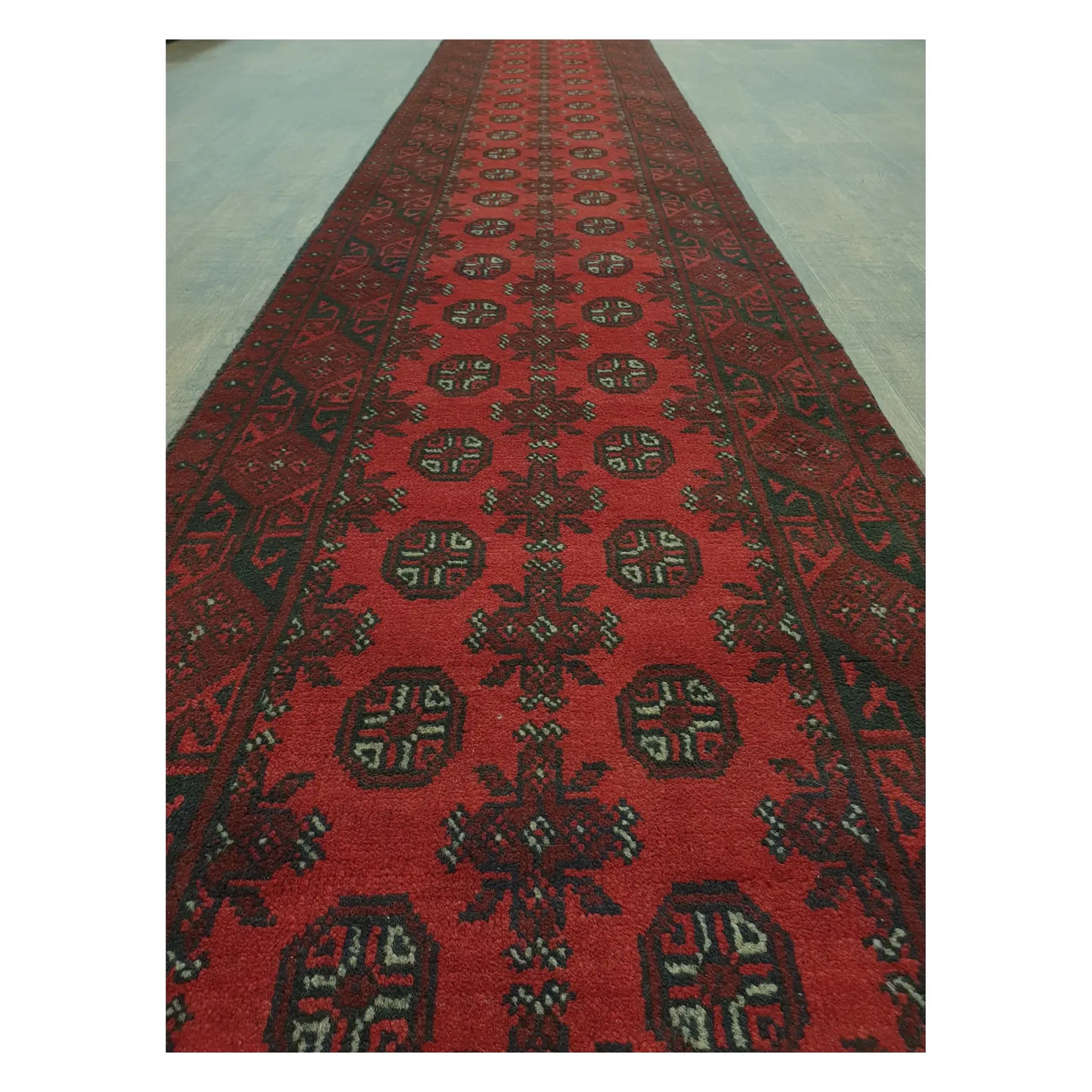 Close-up of Afghan Turkoman runner with repeating red gul motifs and geometric tribal detailing, 568 x 75 cm