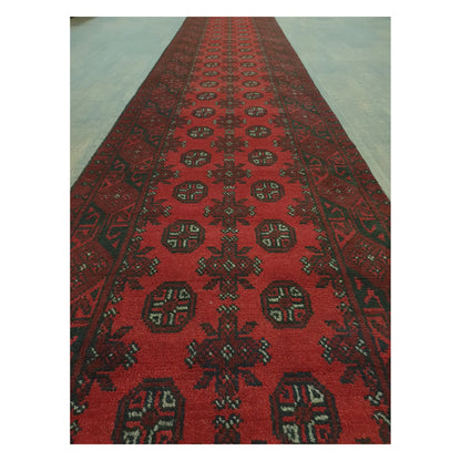 Close-up of Afghan Turkoman runner with repeating red gul motifs and geometric tribal detailing, 568 x 75 cm