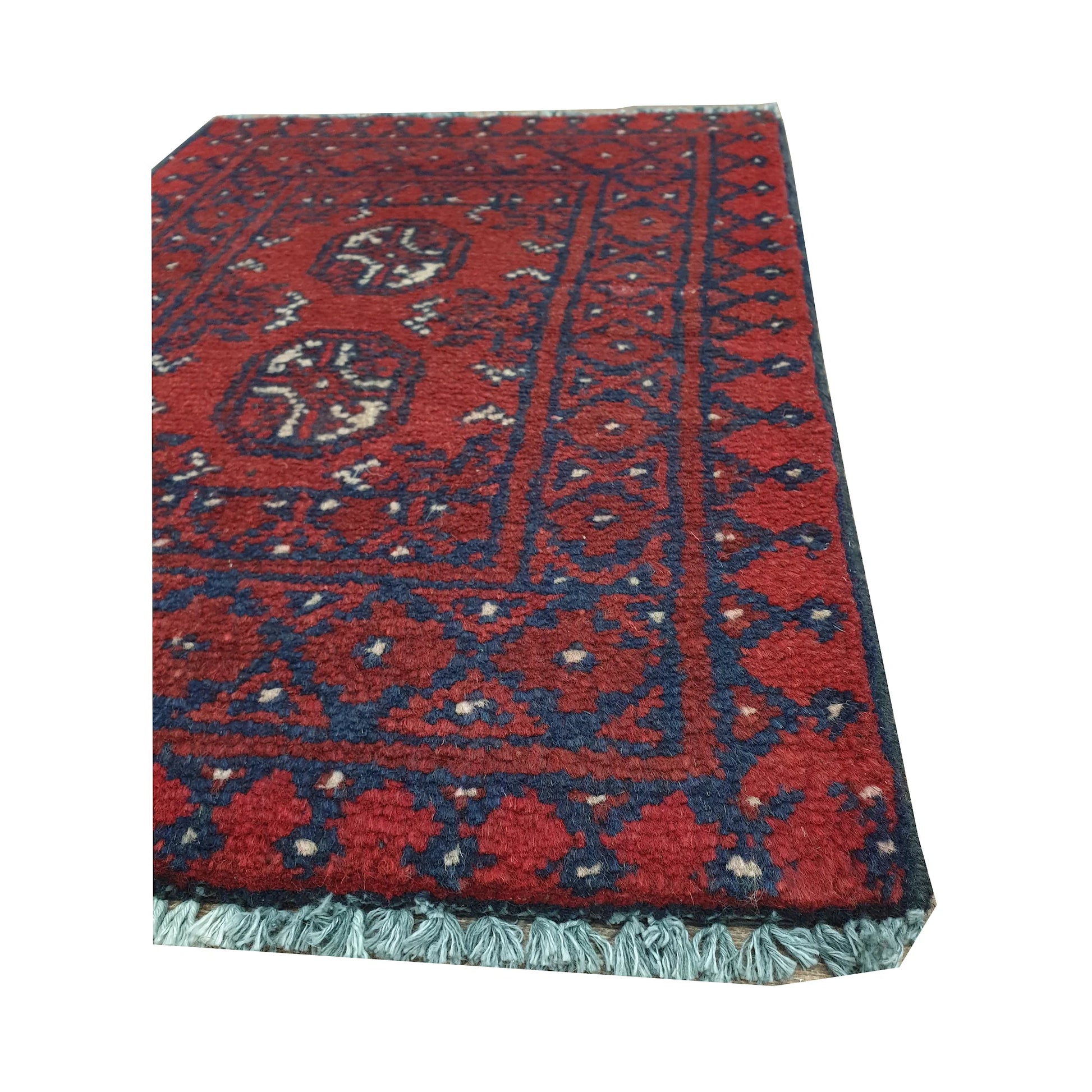 Fringe and border detail of Afghan Turkoman red wool rug showing navy edging, red field and traditional tribal motifs