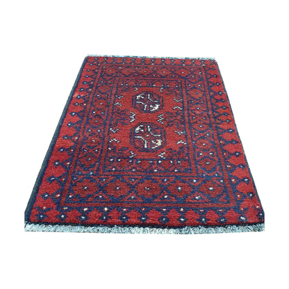 Afghan Turkoman red wool rug detail showing twin gul medallions within a layered tribal frame