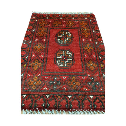 Afghan Turkoman red wool rug detail showing twin octagonal gul medallions within a framed tribal field