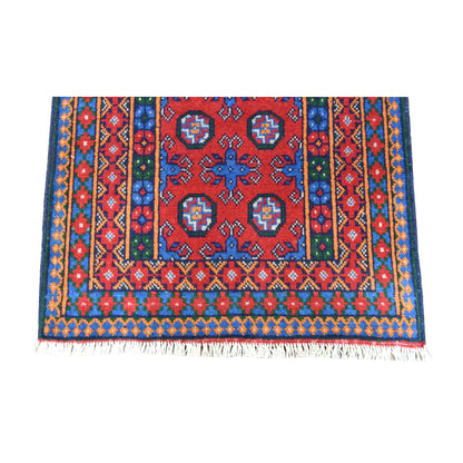 Fringe-end detail of Afghan Turkoman runner showing paired octagonal medallions, blue motifs, diamond borders and pale fringe