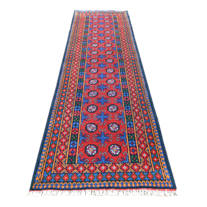 Full view of Afghan Turkoman runner with red field, blue four-pointed motifs, paired octagonal medallions and layered borders, 287 x 83 cm