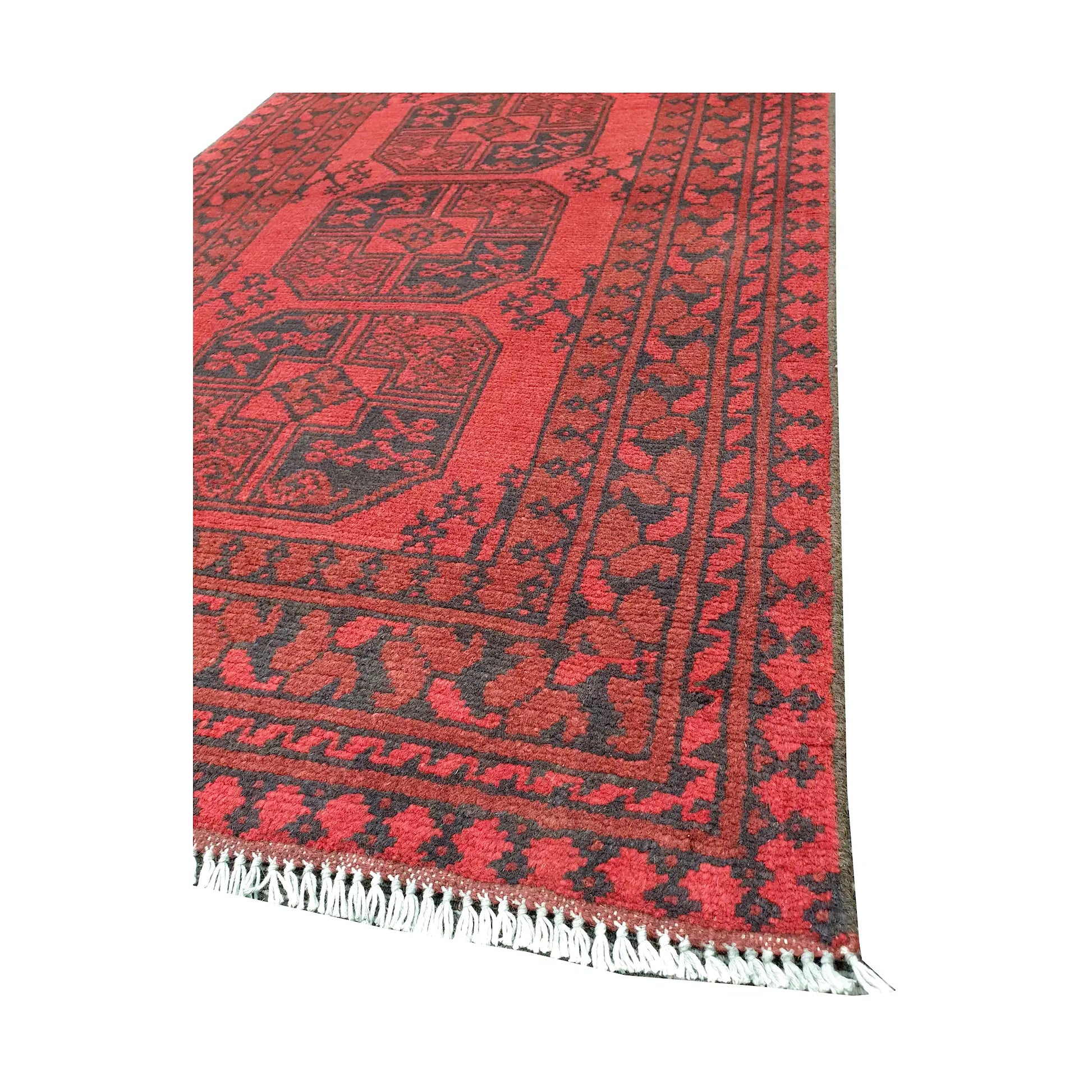 Angled fringe and corner detail of Afghan Turkoman rug showing red wool pile and dark geometric border