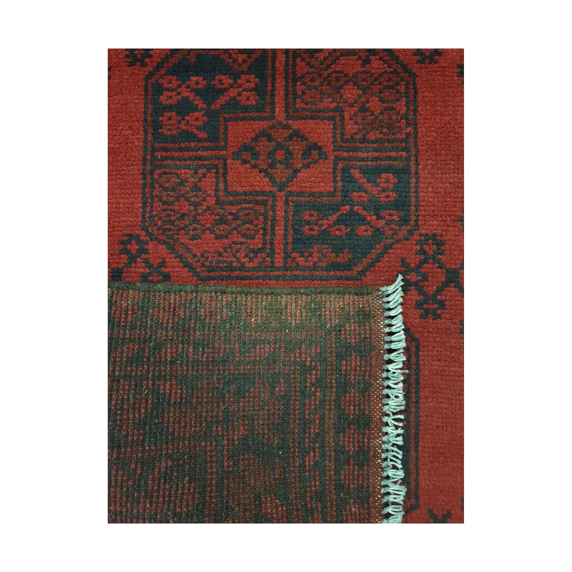 Folded corner detail of Afghan Turkoman rug showing the back of the rug and red front pattern