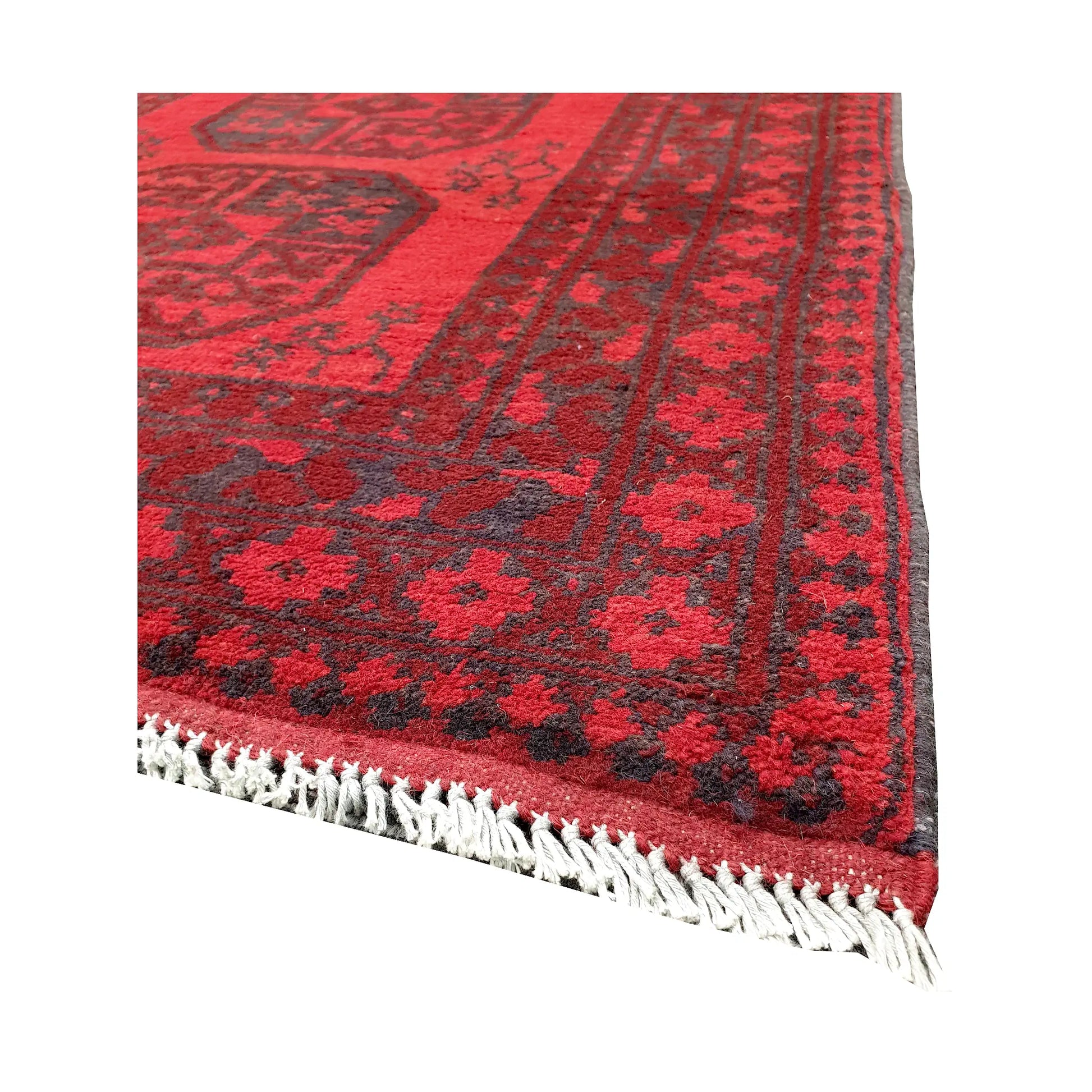 Angled fringe and corner detail of Afghan Turkoman rug showing red wool pile and dark geometric border