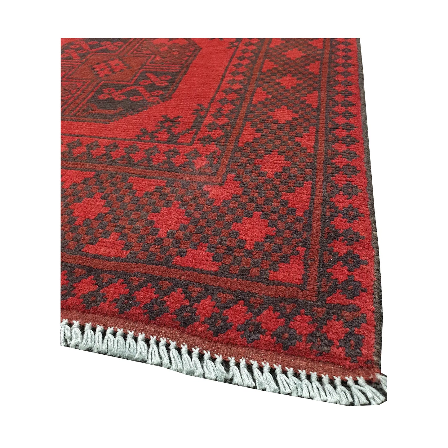 Angled fringe and corner detail of Afghan Turkoman rug showing red wool pile and dark geometric border