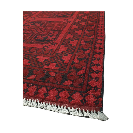 Angled fringe and corner detail of Afghan Turkoman rug showing red wool pile and dark geometric border