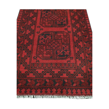 End field and fringe detail of Afghan Turkoman rug with framed red gul panel and charcoal tribal motifs