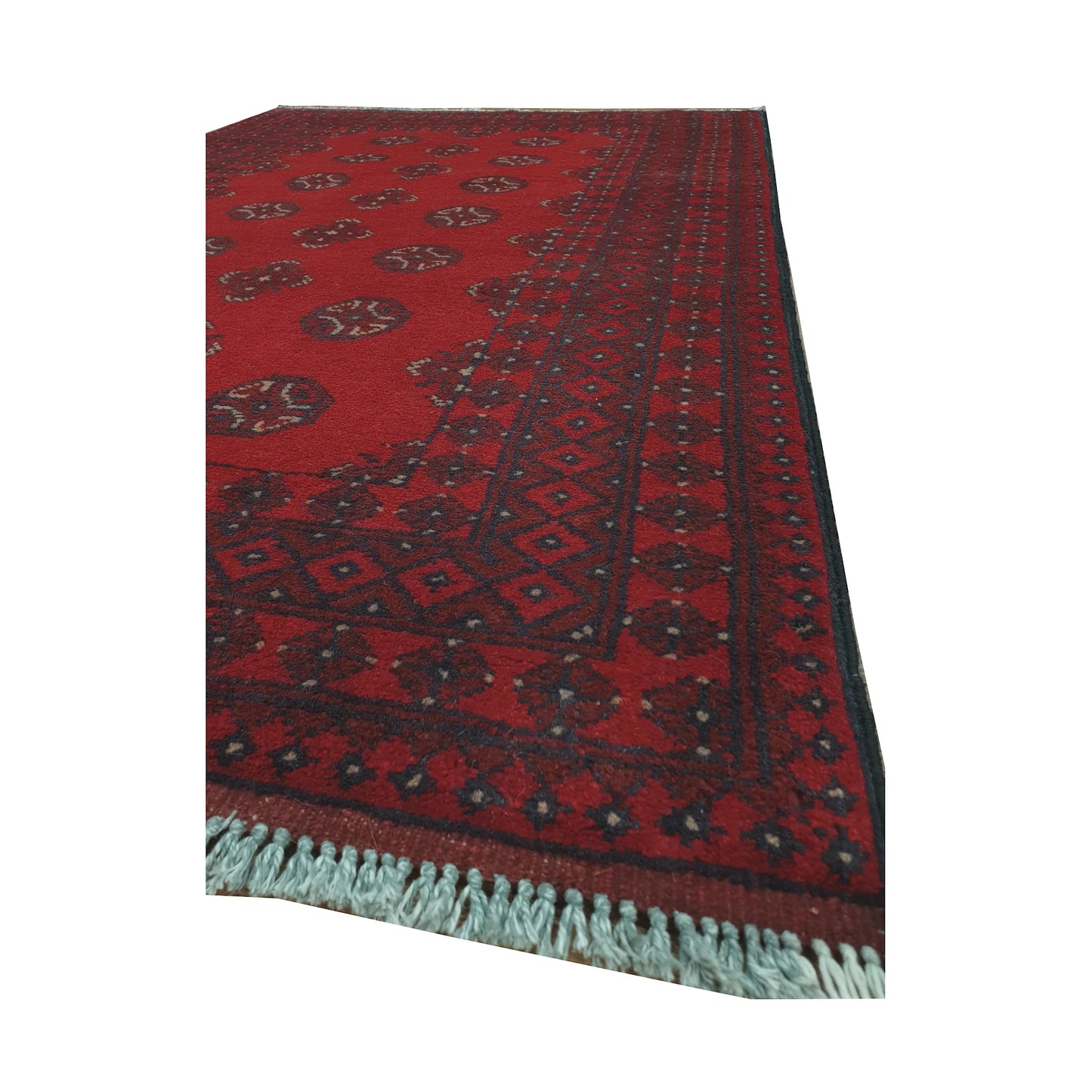 Angled border and fringe detail of Afghan Turkoman rug showing red wool pile, charcoal edging and tribal motifs