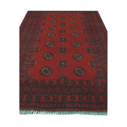 End field and fringe detail of Afghan Turkoman rug with red ground, gul medallions and dark geometric border