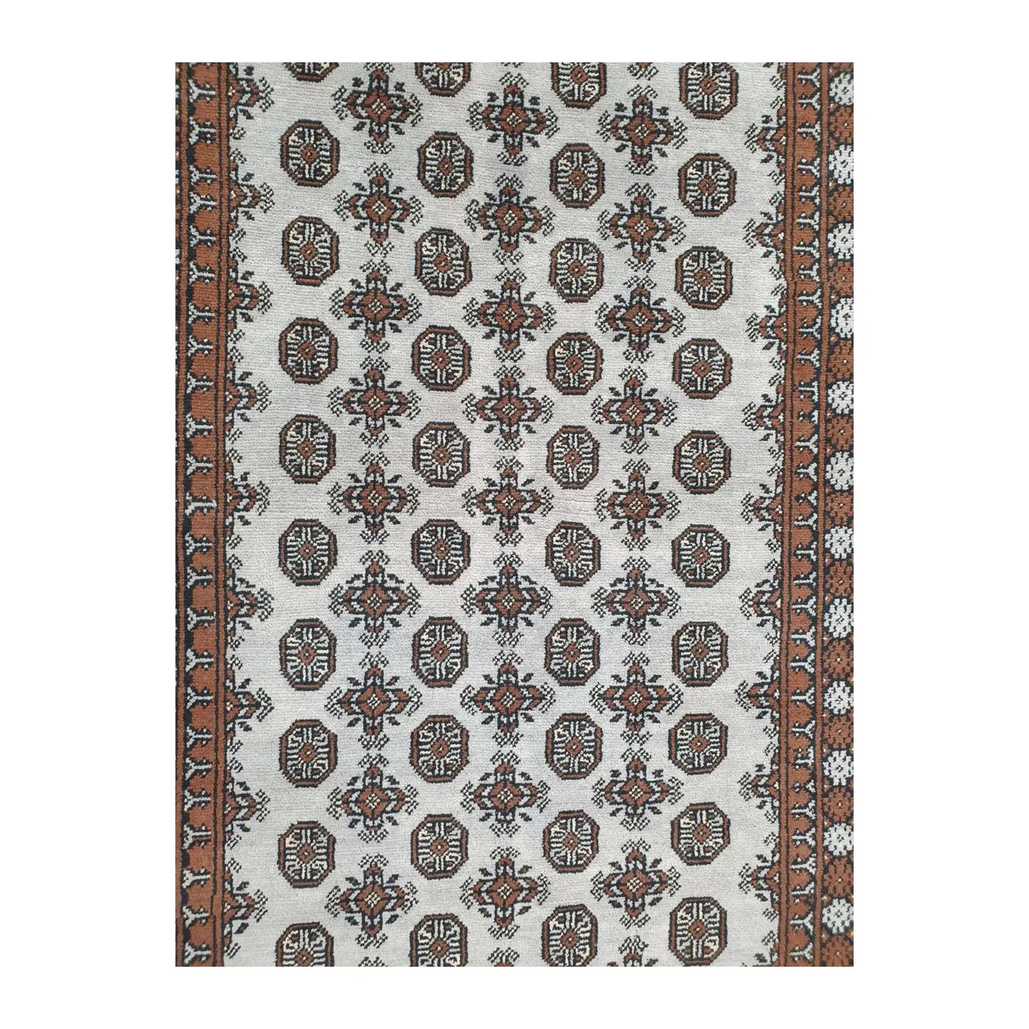 Close-up of Afghan Turkoman rug showing the repeating gul motifs across the off-white field