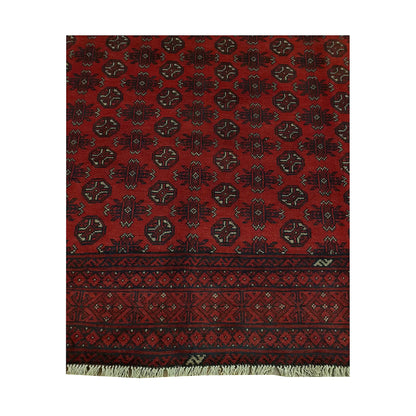 Gul field and border detail of Afghan Turkoman rug showing repeated medallions, deep red ground and dark geometric border