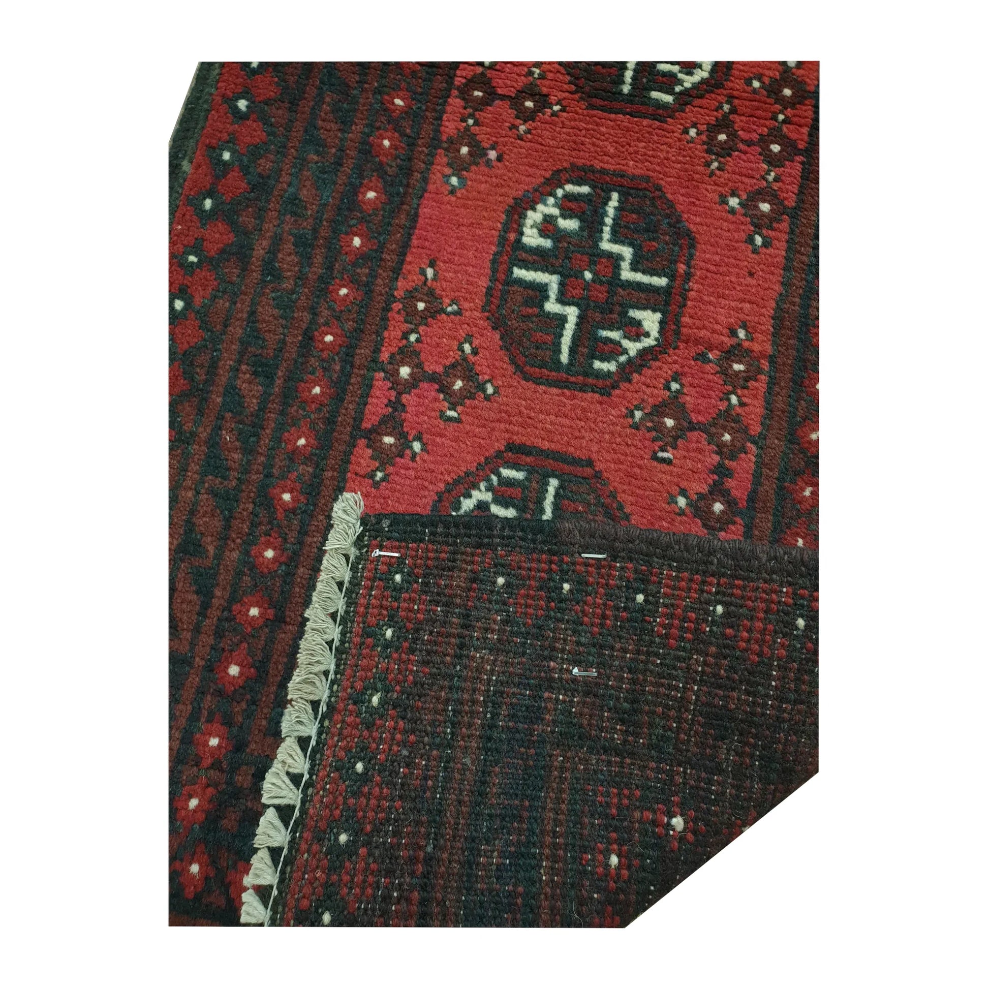Folded-corner detail of Afghan Turkoman runner rug showing the patterned field, reverse weave and rug edge