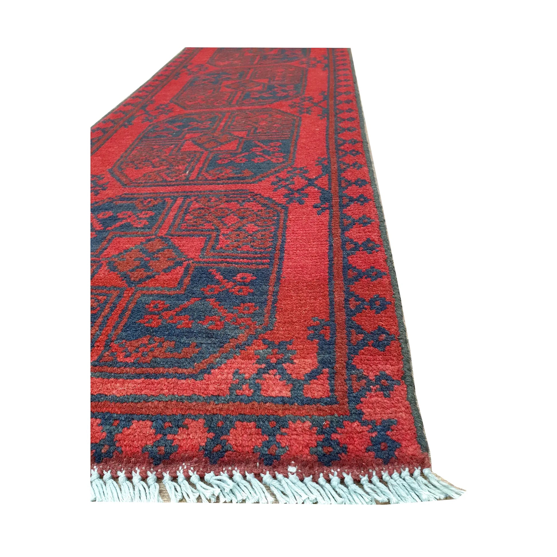 Angled border and fringe detail of Afghan Turkoman runner rug showing red wool pile, charcoal edging and tribal motifs