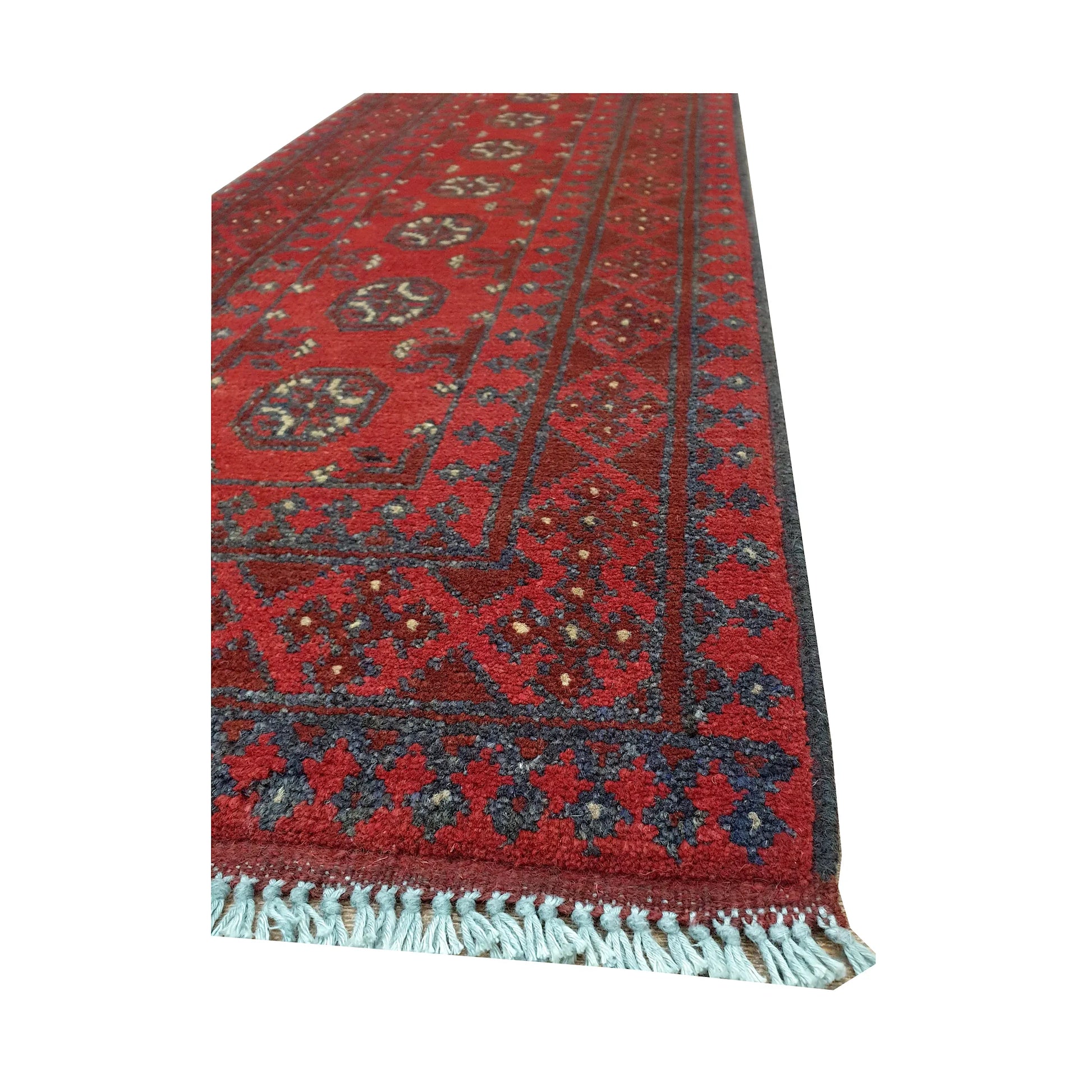 Angled border and fringe detail of Afghan Turkoman runner rug showing red wool pile, charcoal edging and tribal motifs