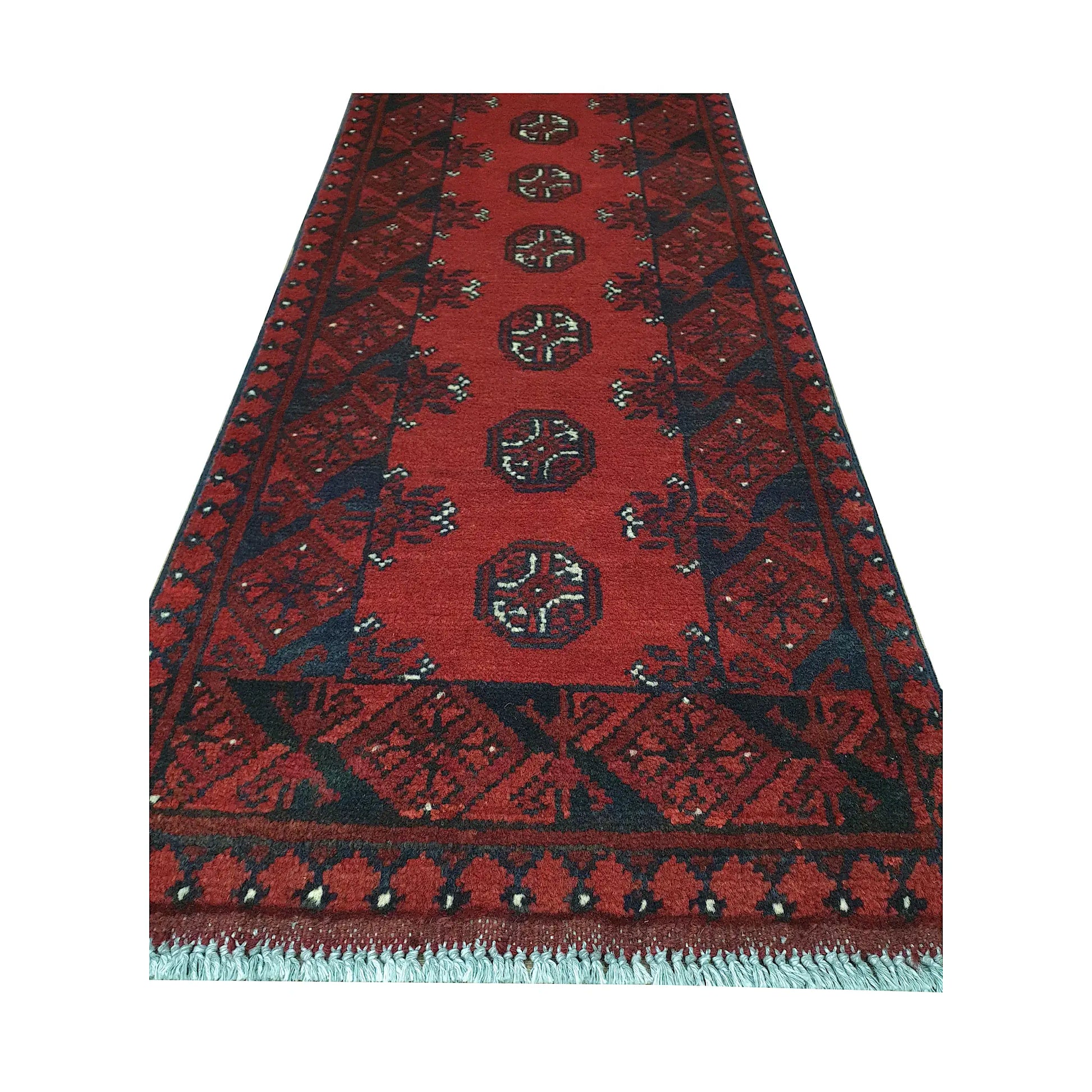 End field and fringe detail of Afghan Turkoman runner rug with seven round gul medallions, red ground and dark border