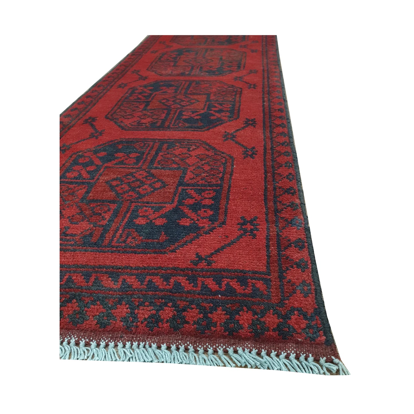 Angled border and fringe detail of Afghan Turkoman runner rug showing red wool pile, charcoal edging and tribal motifs