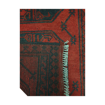 Folded corner detail of Afghan Turkoman runner rug showing the back of the rug, fringe and red front pattern