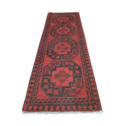 End field detail of Afghan Turkoman runner rug with octagonal gul medallions, red ground and visible fringe