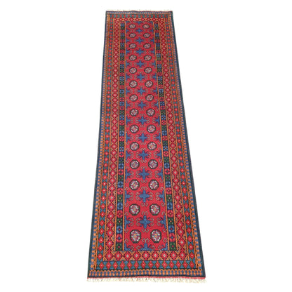 Full view of Afghan Turkoman runner rug, 287 x 83 cm, with a red field and blue geometric medallions