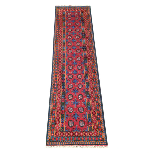 Full view of Afghan Turkoman runner rug, 287 x 83 cm, with a red field and blue geometric medallions
