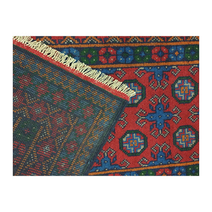 Folded corner showing the patterned front, reverse weave and cream fringe of the Turkoman runner
