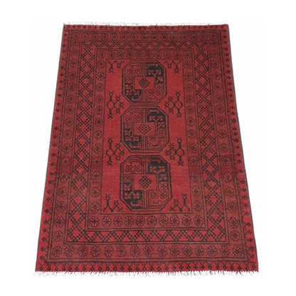 Angled view of Afghan Turkoman wool rug with red field and three gul-style medallions, 144 x 102 cm