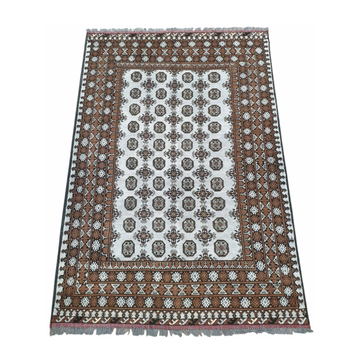 Angled full view of Afghan Turkoman wool rug showing the off-white gul-patterned field and layered warm brown border