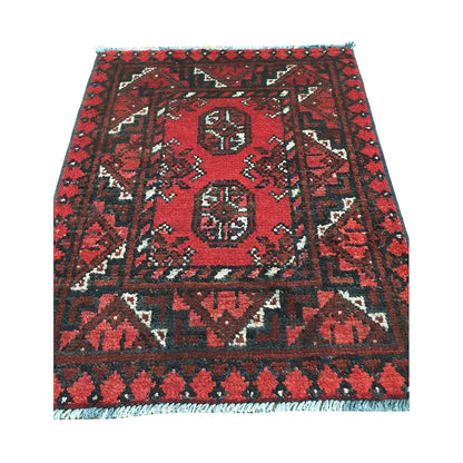 Afghan Turkoman wool rug detail showing twin gul medallions, red field and angular tribal border