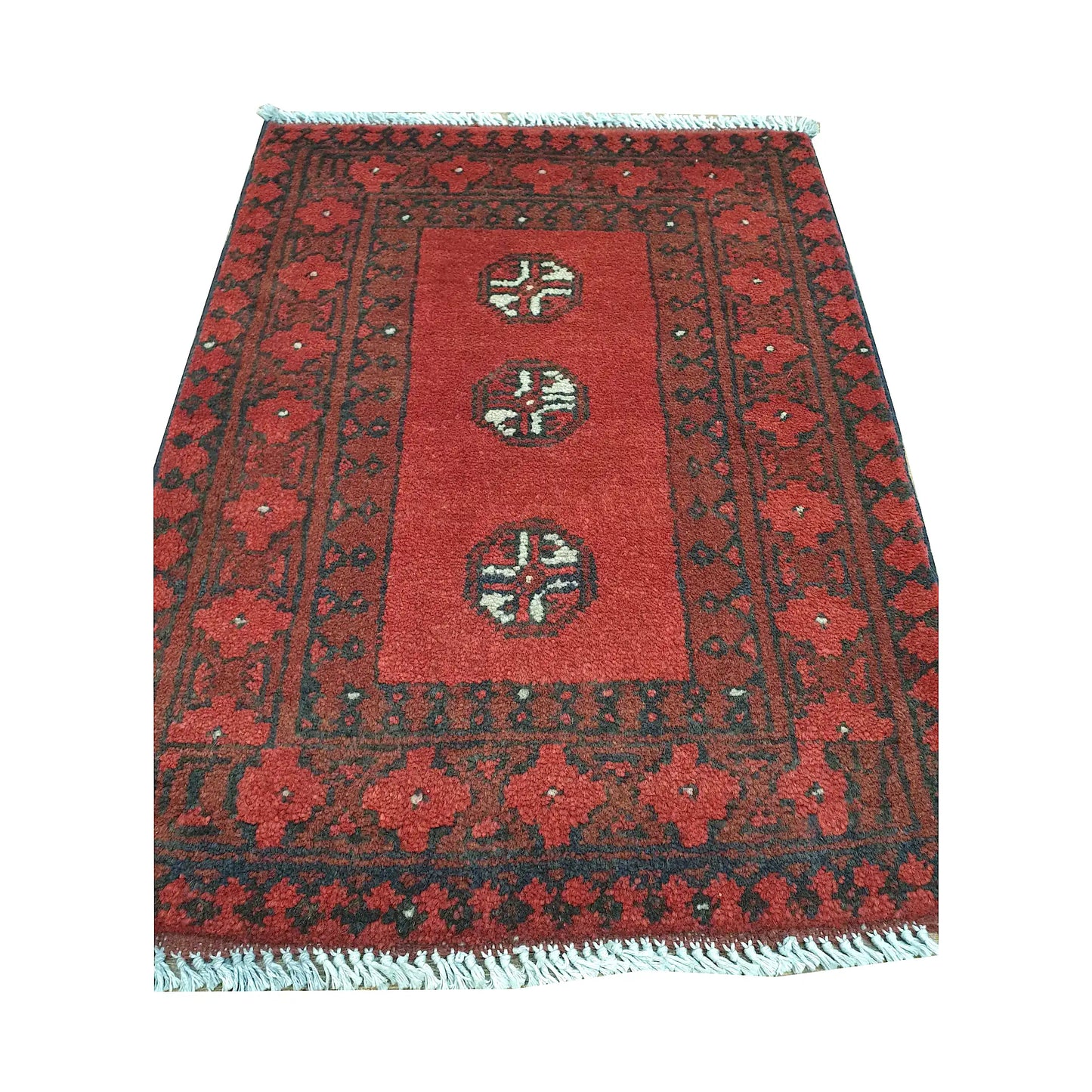 Afghan Turkoman wool rug front detail showing three spaced quartered guls within an open red field